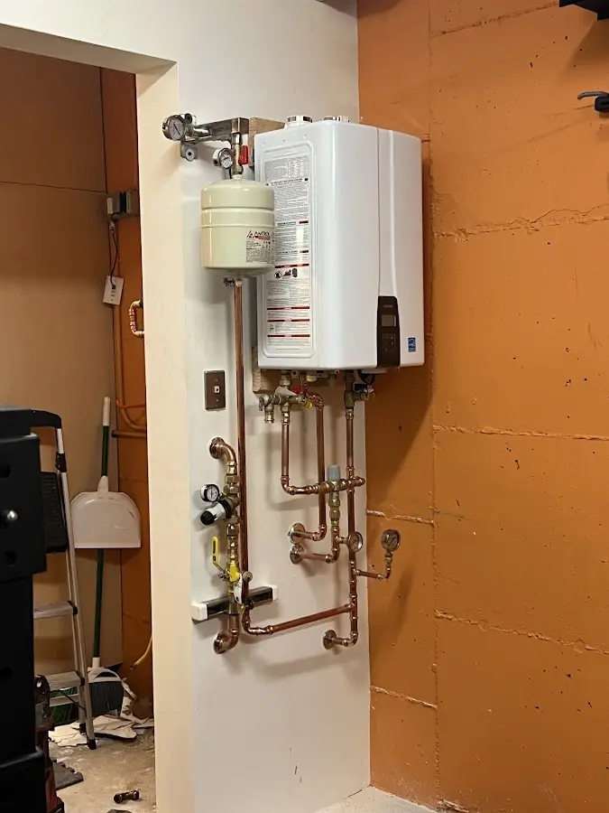 Plumbing technician inspecting water heater connections in Rockville